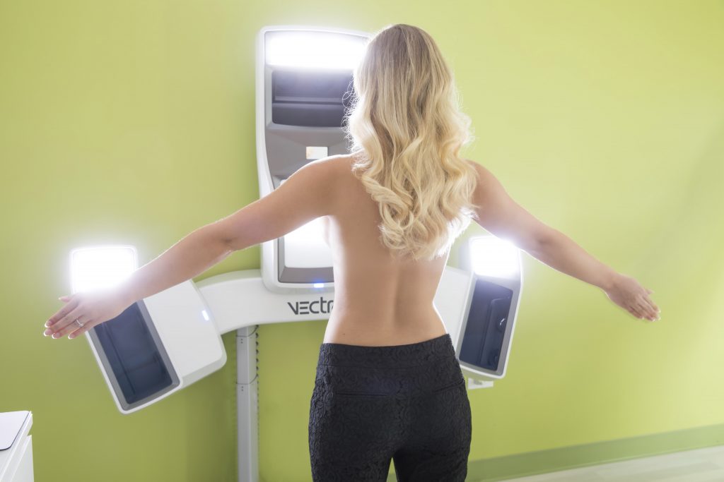 blonde woman using vectra 3d imaging machine